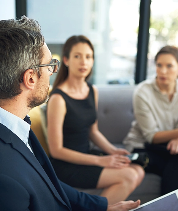 Executive coach leading a one-on-one discussion with a business leader in a modern office setting